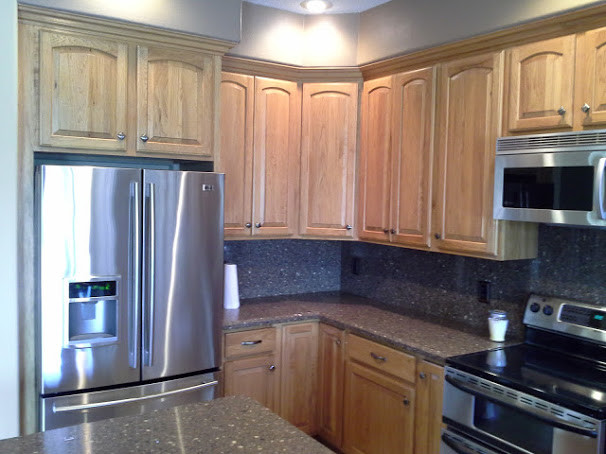 Mid-sized transitional ceramic tile open concept kitchen photo in Orlando with a double-bowl sink, raised-panel cabinets, distressed cabinets, quartz countertops, beige backsplash, stainless steel appliances and an island