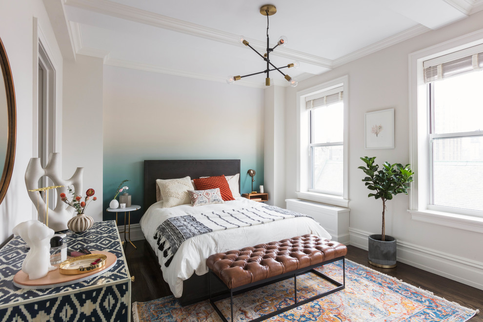 This is an example of a mid-sized eclectic bedroom in New York with dark hardwood floors, multi-coloured walls and no fireplace.