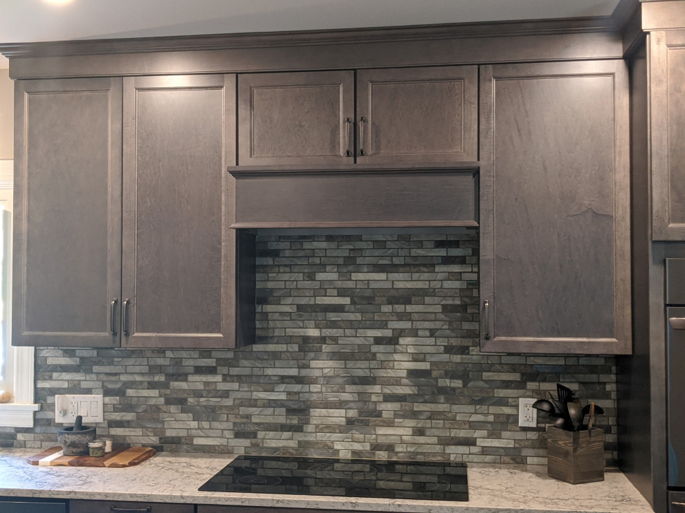 Mid-sized transitional l-shaped eat-in kitchen photo in Providence with a farmhouse sink, flat-panel cabinets, gray cabinets, quartz countertops, multicolored backsplash, mosaic tile backsplash, stainless steel appliances, an island and beige countertops
