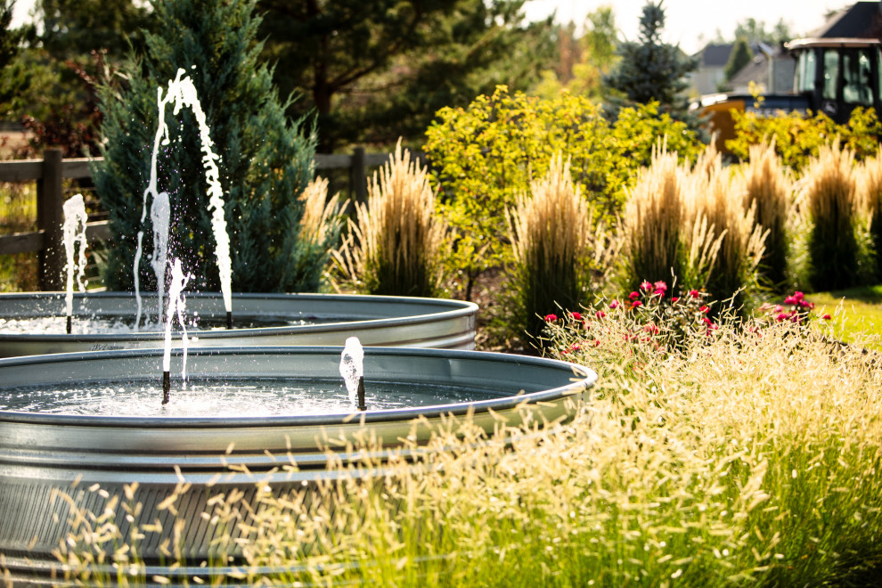Photo of a mid-sized country backyard full sun formal garden in Denver with with waterfall.