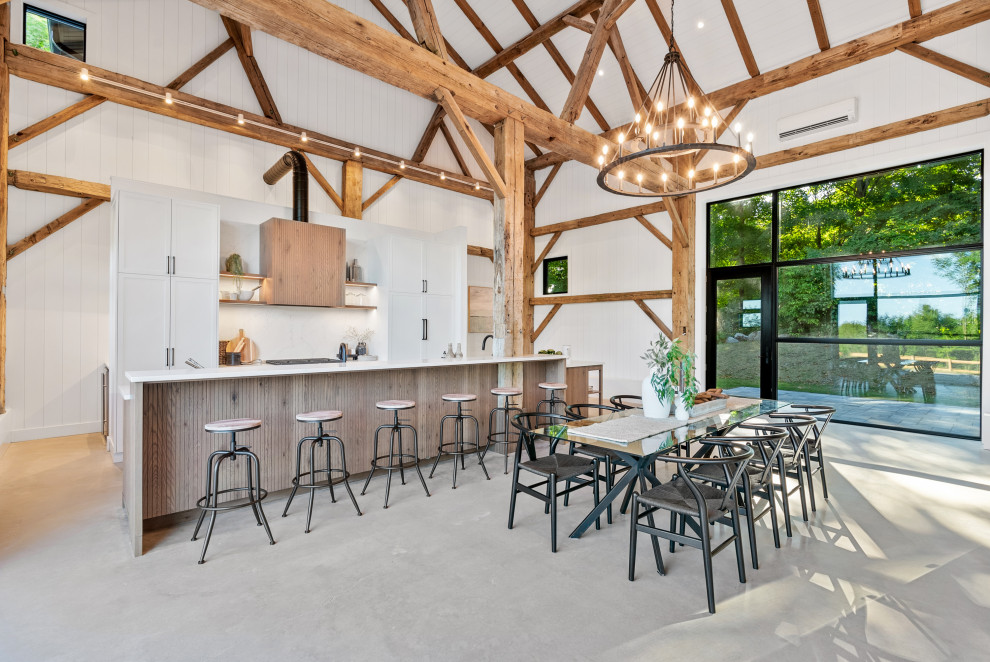 Inspiration for a large transitional galley eat-in kitchen remodel with an undermount sink, shaker cabinets, white cabinets, quartz countertops, white backsplash, quartz backsplash, paneled appliances, an island and white countertops