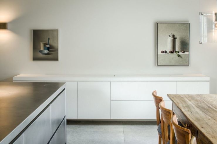 Inspiration for a large modern kitchen in Boston with stainless steel benchtops, white splashback, stainless steel appliances, terra-cotta floors, with island, white floor and white benchtop.