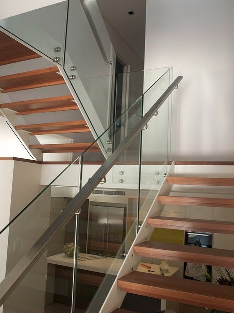 Photo of a mid-sized contemporary wood l-shaped staircase in Sydney.