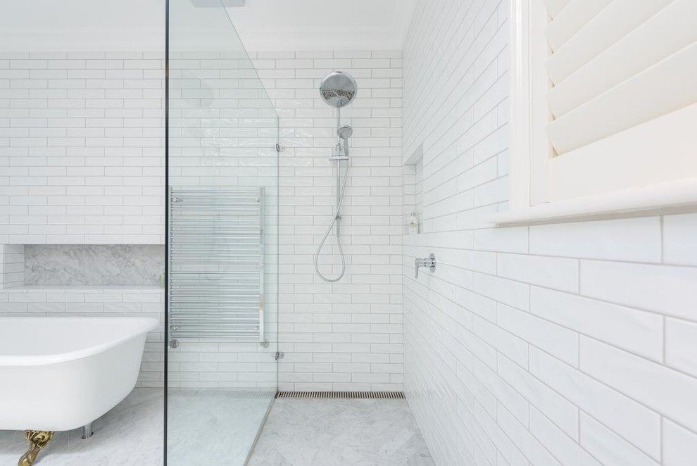 Design ideas for a large traditional bathroom in Melbourne with flat-panel cabinets, white cabinets, a claw-foot tub, a one-piece toilet, white tile, ceramic tile, white walls, marble floors, a vessel sink, marble benchtops and multi-coloured floor.