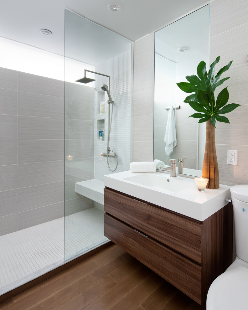 Inspiration for a modern bathroom in Toronto with an integrated sink, flat-panel cabinets, dark wood cabinets, an open shower, gray tile and an open shower.