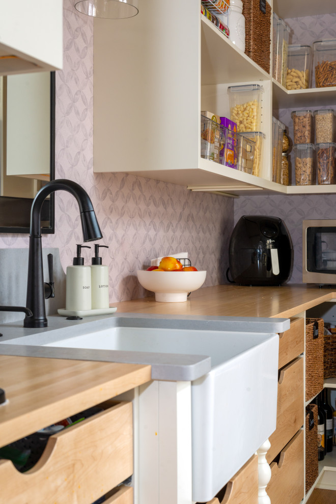 Large medium tone wood floor and exposed beam eat-in kitchen photo with white backsplash, stainless steel appliances and an island