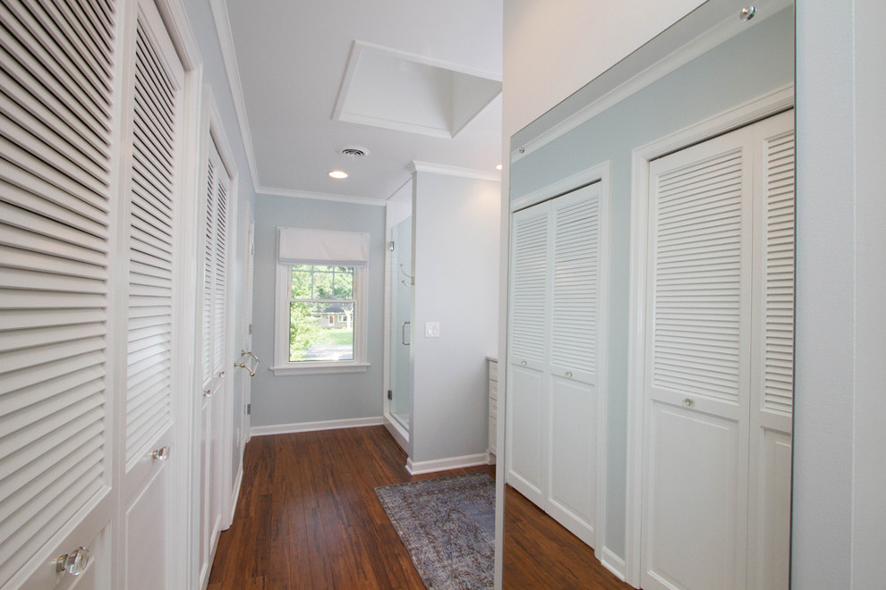 Inspiration for a mid-sized transitional master white tile and ceramic tile bamboo floor and brown floor closet remodel with raised-panel cabinets, white cabinets, a two-piece toilet, blue walls, an undermount sink and granite countertops