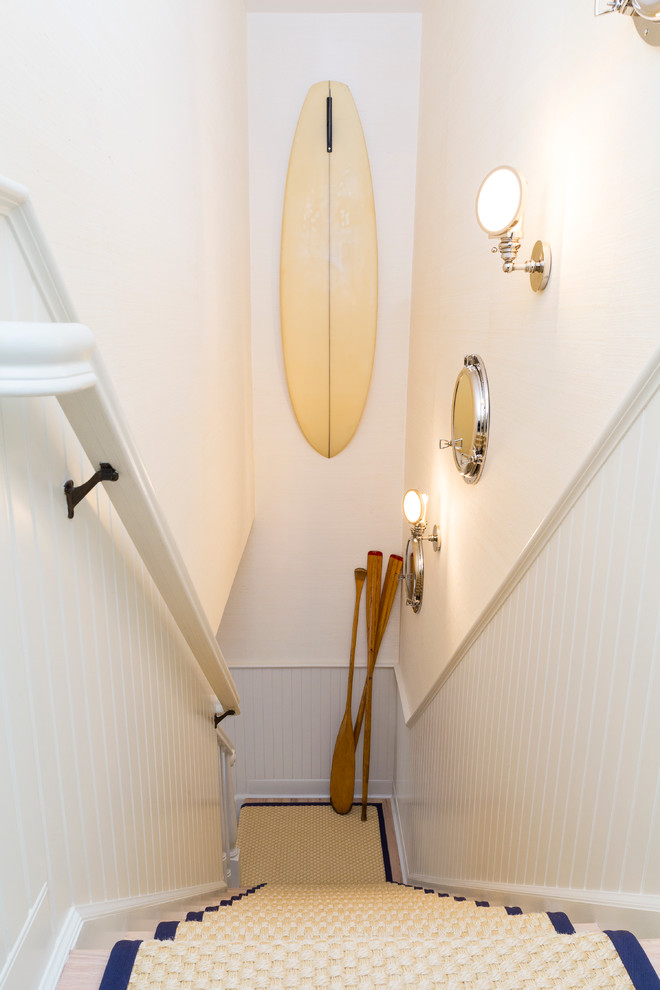 Inspiration for a mid-sized beach style wood l-shaped staircase in New York with painted wood risers.