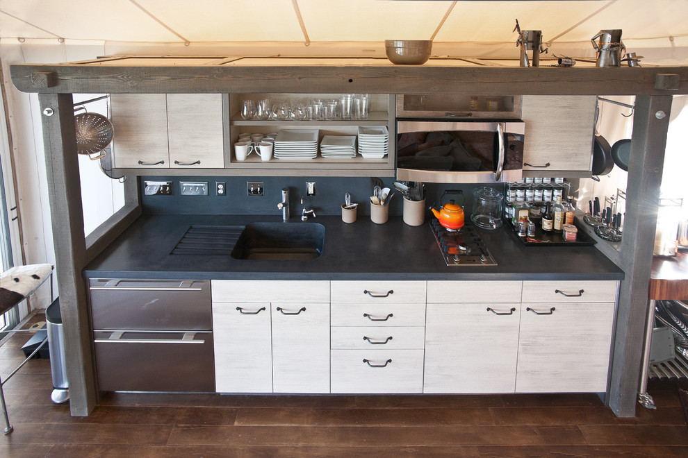 Kitchen - rustic kitchen idea with an integrated sink, concrete countertops, gray backsplash and cement tile backsplash