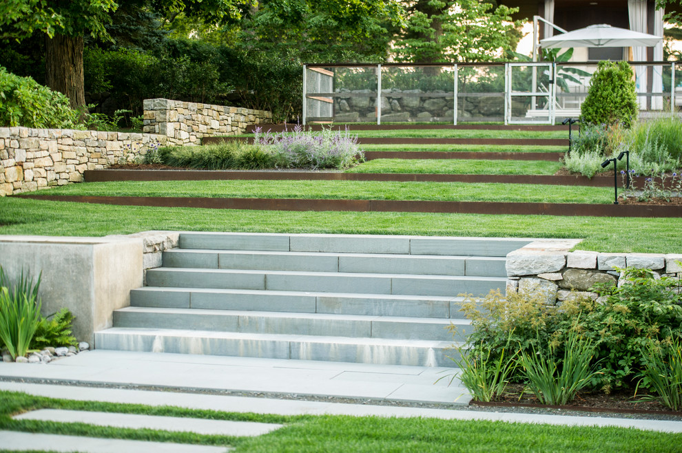 Inspiration for a large contemporary full sun hillside concrete paver landscaping in New York.