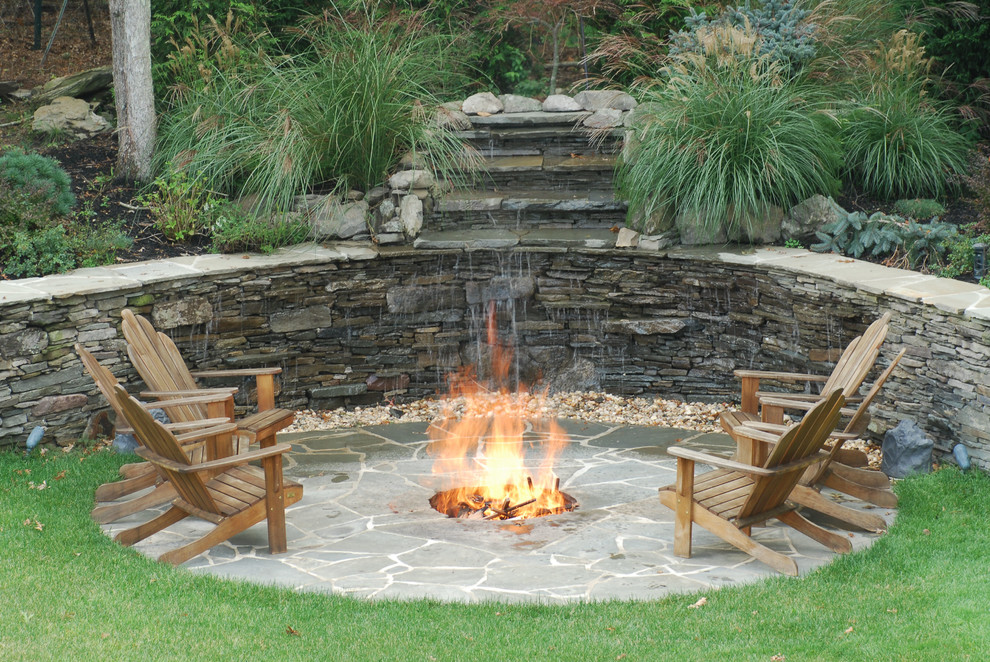 Expansive transitional backyard garden in New York with a fire feature.