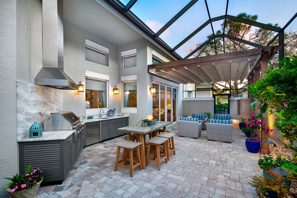 Example of a large transitional backyard stone patio design in Other with a roof extension and a bbq area