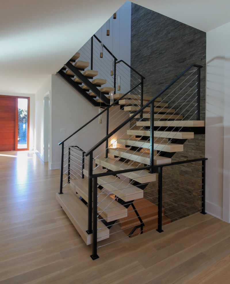 Staircase - large eclectic wooden floating metal railing and brick wall staircase idea in DC Metro