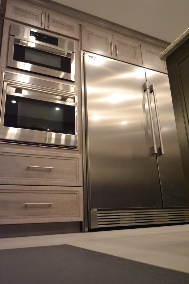 Example of a mid-sized transitional u-shaped eat-in kitchen design in Toronto with recessed-panel cabinets and an island
