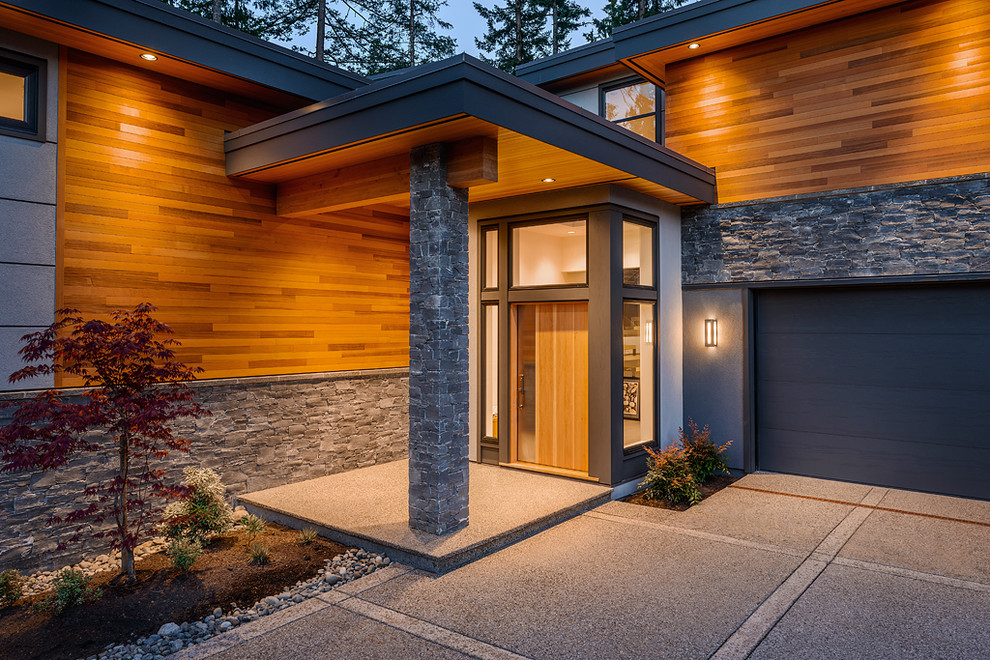 Inspiration for a contemporary front door in Vancouver with a single front door and a medium wood front door.