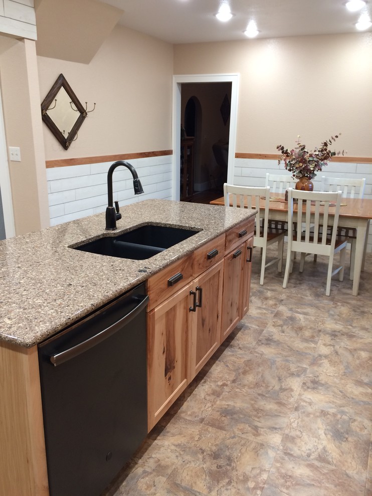 Mid-sized mountain style l-shaped vinyl floor and multicolored floor eat-in kitchen photo with an undermount sink, recessed-panel cabinets, medium tone wood cabinets, granite countertops, black appliances, an island and gray countertops