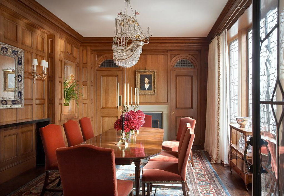 Large traditional separate dining room in New York with brown walls, dark hardwood floors, a standard fireplace and a metal fireplace surround.