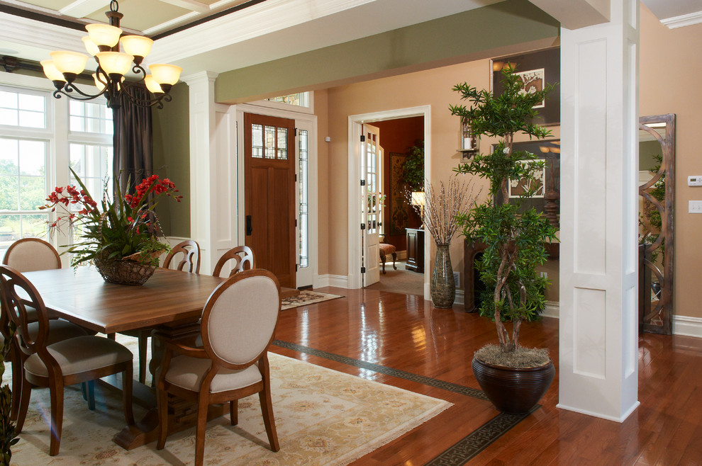 This is an example of a large transitional open plan dining in Other with green walls and medium hardwood floors.