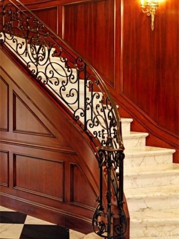 Large traditional curved staircase in San Diego.