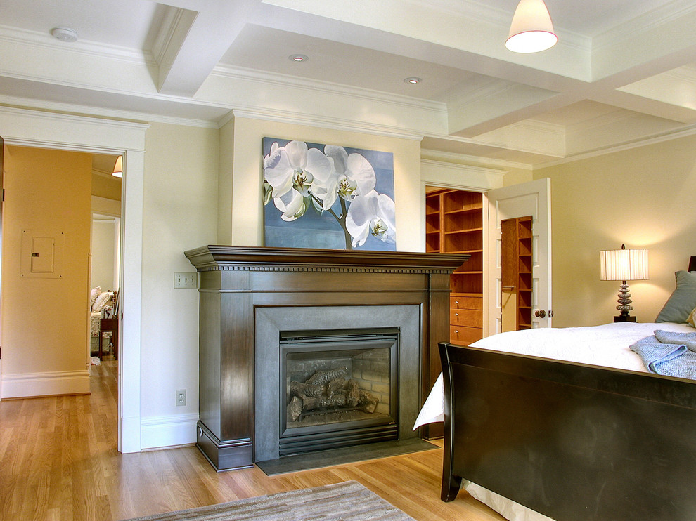Traditional bedroom in Seattle with beige walls and a standard fireplace.