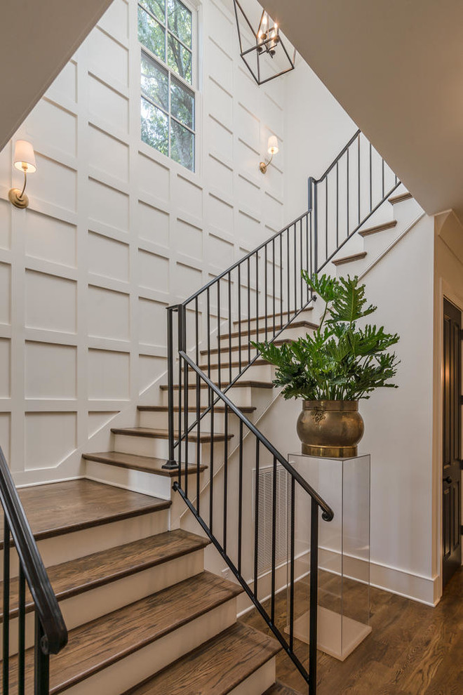 Transitional wood l-shaped staircase in Nashville with painted wood risers and metal railing.