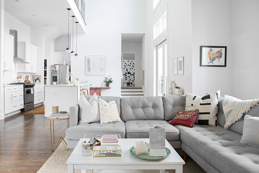 Scandinavian living room in Nashville with white walls, dark hardwood floors and brown floor.