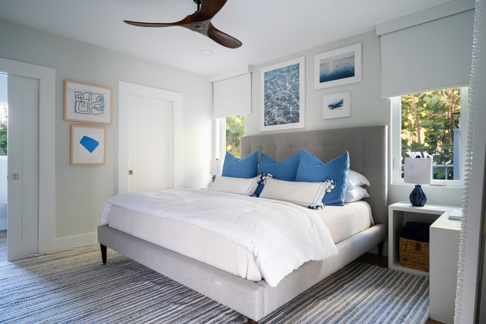 Mid-sized beach style guest bedroom in Miami with grey walls, porcelain floors and brown floor.