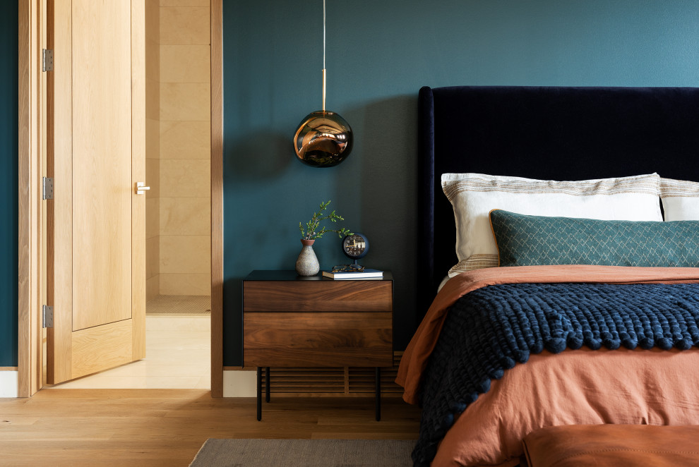 Inspiration for a country bedroom in Other with blue walls, medium hardwood floors and brown floor.
