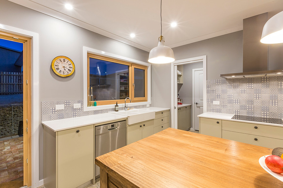 Mid-sized traditional l-shaped kitchen pantry in Canberra - Queanbeyan with a farmhouse sink, quartz benchtops, multi-coloured splashback, porcelain splashback, stainless steel appliances, concrete floors and with island.