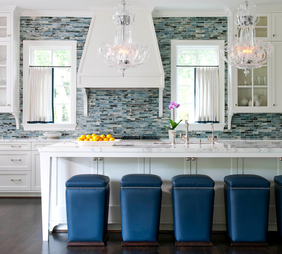 Photo of a transitional galley kitchen in Dallas with shaker cabinets, white cabinets, marble benchtops, blue splashback, matchstick tile splashback, dark hardwood floors and with island.
