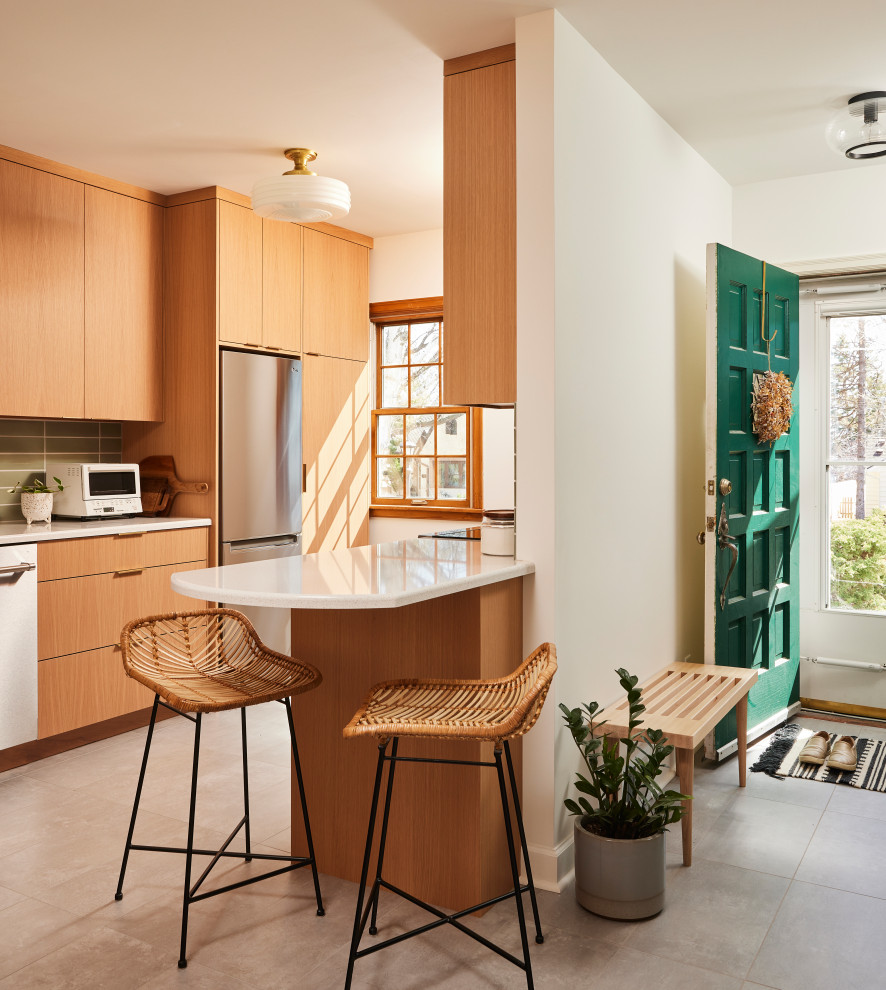 Mid-sized scandinavian galley separate kitchen in Minneapolis with an undermount sink, flat-panel cabinets, light wood cabinets, quartz benchtops, green splashback, ceramic splashback, stainless steel appliances, porcelain floors, a peninsula, grey floor and white benchtop.