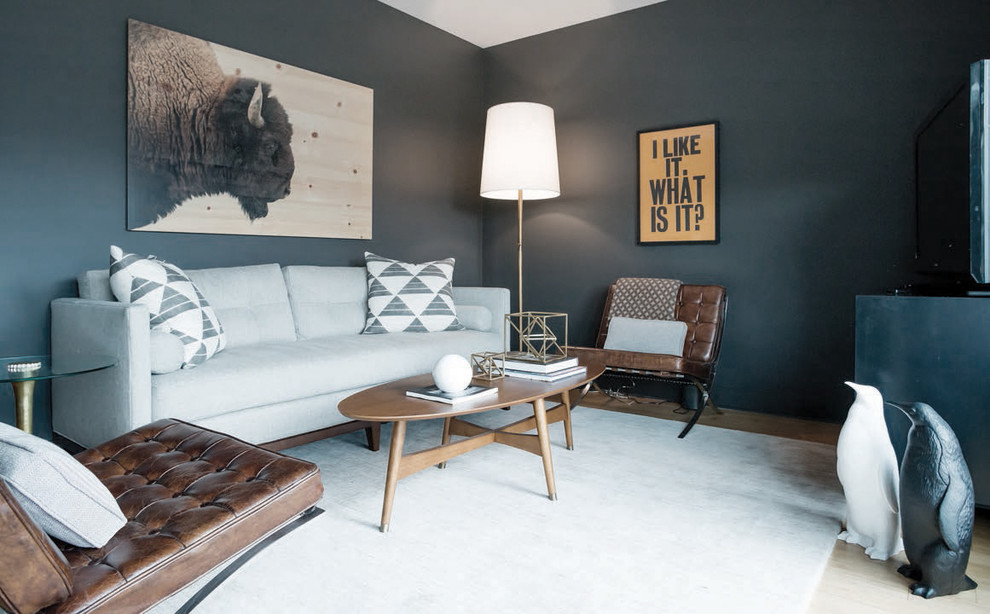 Example of a small mid-century modern light wood floor family room design in Nashville with black walls and no fireplace