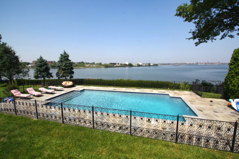 Inspiration for a traditional backyard pool in New York with concrete pavers.