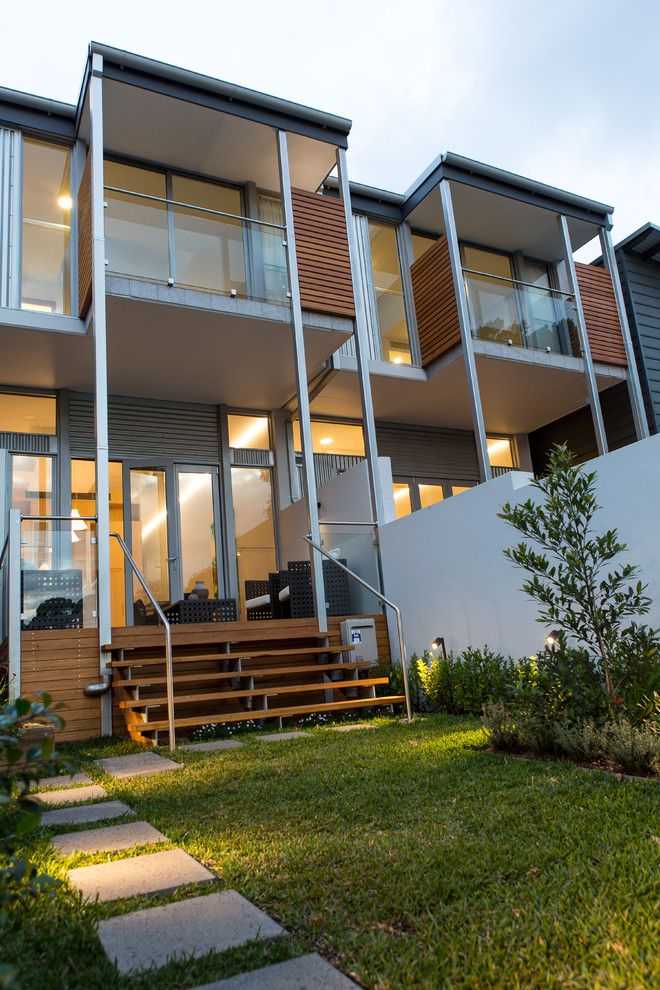 Photo of a small modern backyard patio in Sydney with decking and a roof extension.