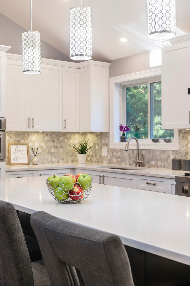 Large transitional l-shaped medium tone wood floor and brown floor eat-in kitchen photo in Vancouver with an undermount sink, shaker cabinets, white cabinets, quartzite countertops, multicolored backsplash, marble backsplash, stainless steel appliances, an island and white countertops