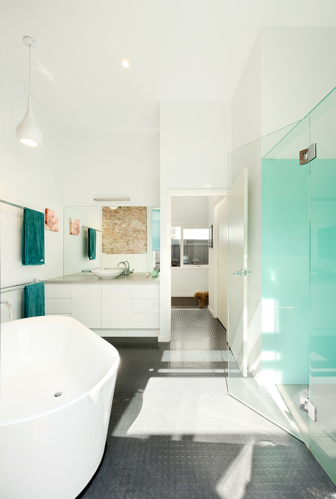 Design ideas for a mid-sized contemporary master bathroom in Melbourne with flat-panel cabinets, white cabinets, a freestanding tub, an alcove shower, green tile, glass sheet wall, white walls, a vessel sink and engineered quartz benchtops.