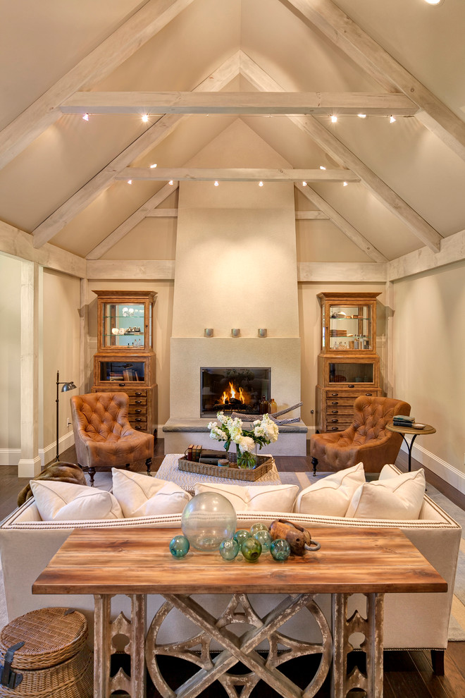 This is an example of a large transitional enclosed living room in Seattle with green walls, a standard fireplace, a plaster fireplace surround and no tv.