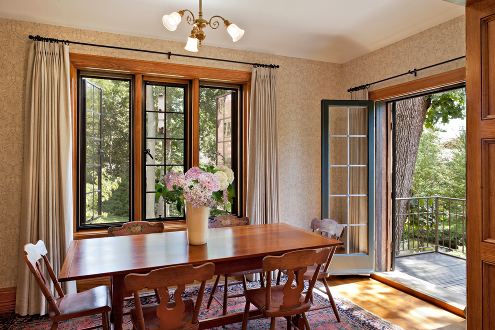 Traditional dining room in Denver with multi-coloured walls and medium hardwood floors.