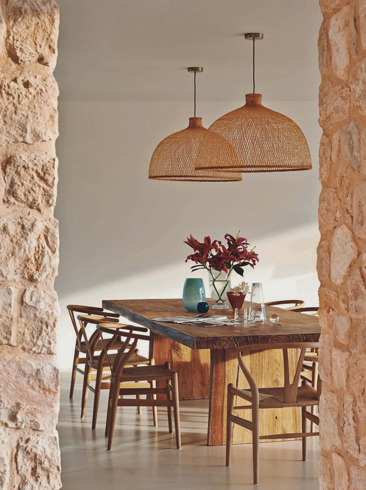Inspiration for a mid-sized mediterranean open plan dining in Milan with white walls and no fireplace.
