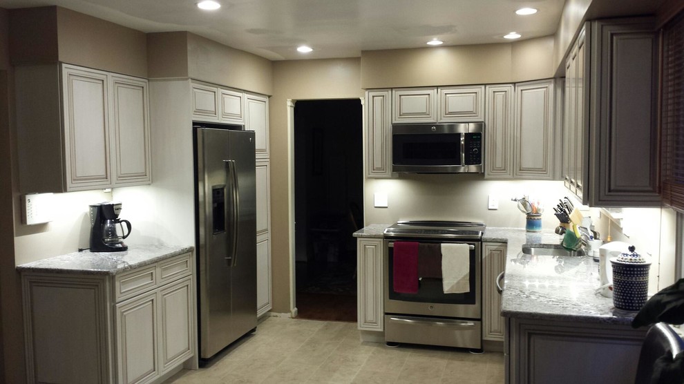Mid-sized transitional l-shaped open concept kitchen photo in Newark with a single-bowl sink, beaded inset cabinets, marble countertops and stainless steel appliances