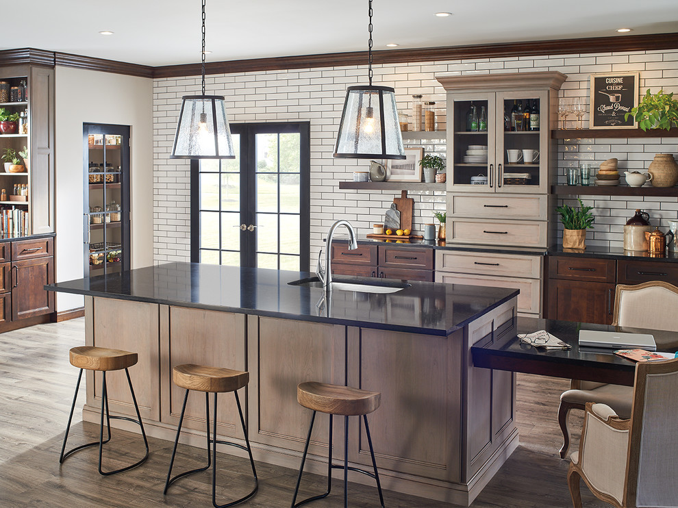 Huge transitional medium tone wood floor kitchen photo in Indianapolis with dark wood cabinets, beige backsplash, subway tile backsplash and an island
