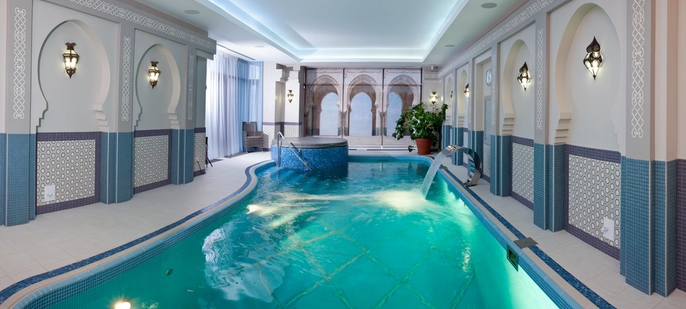 This is an example of an asian indoor rectangular pool in Moscow with a water feature and tile.