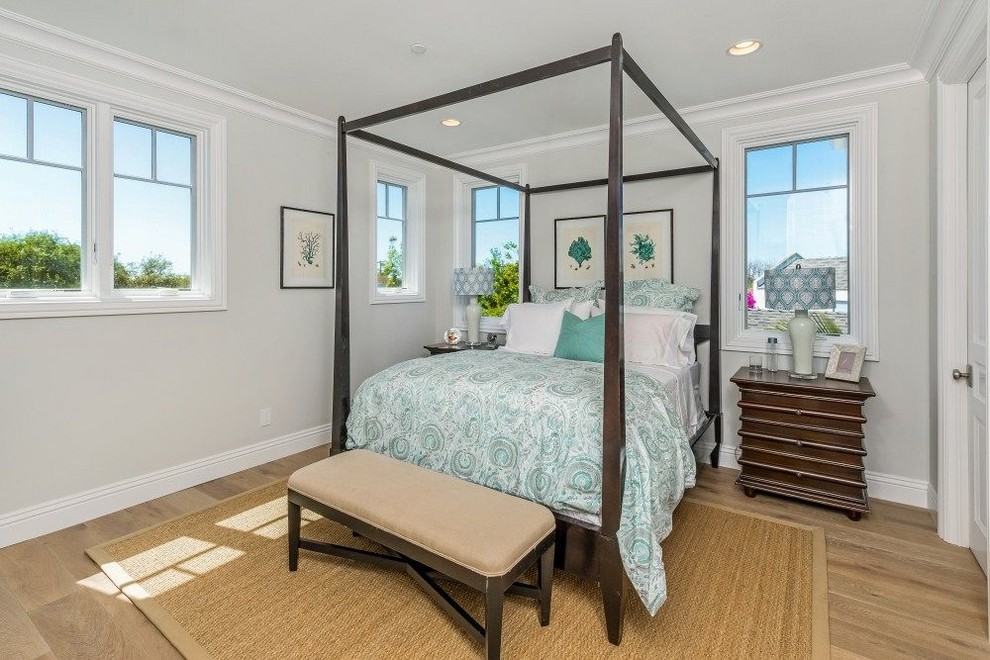 Inspiration for a traditional bedroom in Los Angeles with grey walls and light hardwood floors.