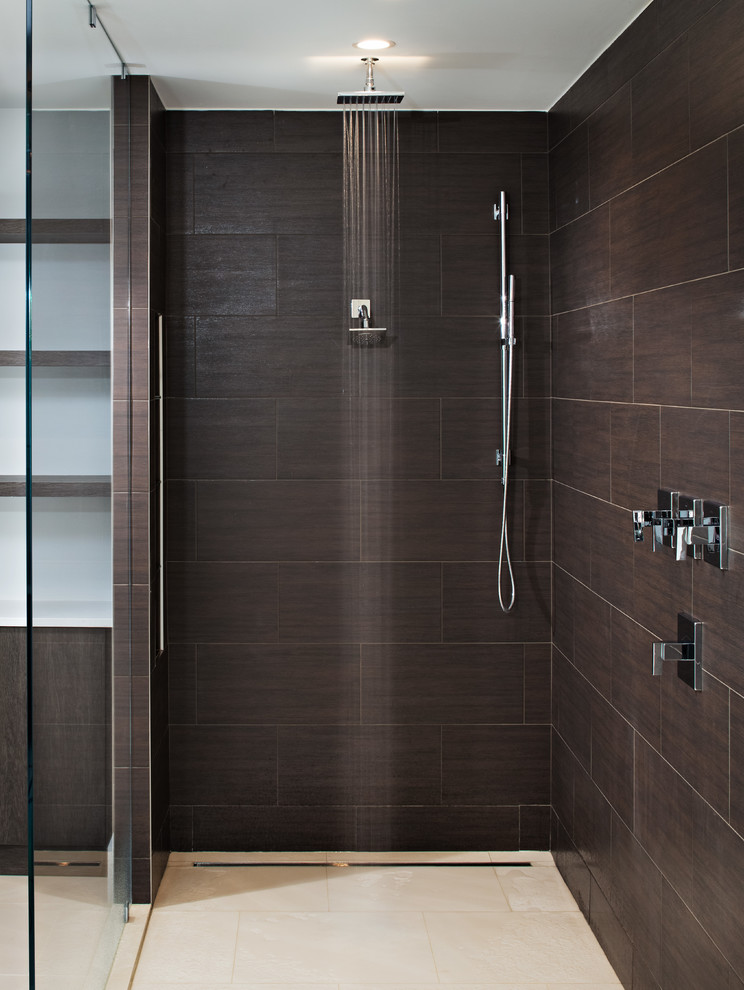 Photo of a large modern master bathroom in DC Metro with flat-panel cabinets, white cabinets, a freestanding tub, a curbless shower, a one-piece toilet, brown tile, porcelain tile, white walls, porcelain floors, a vessel sink, engineered quartz benchtops, beige floor, an open shower and white benchtops.
