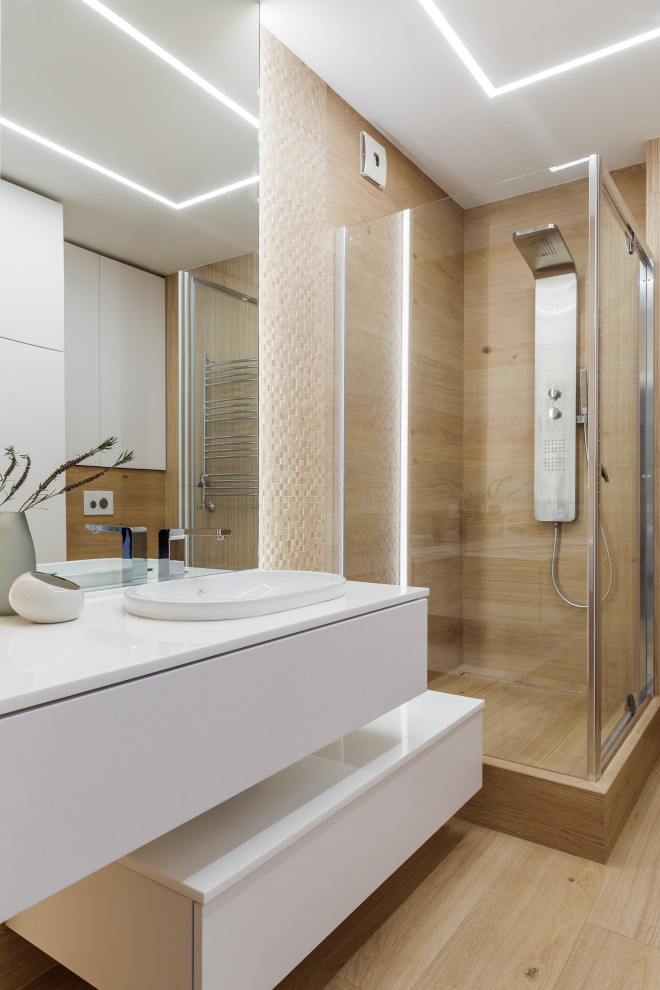 Photo of a mid-sized contemporary 3/4 bathroom in Other with flat-panel cabinets, white cabinets, a corner shower, beige tile, a drop-in sink, beige floor, a hinged shower door, white benchtops, a single vanity and a floating vanity.