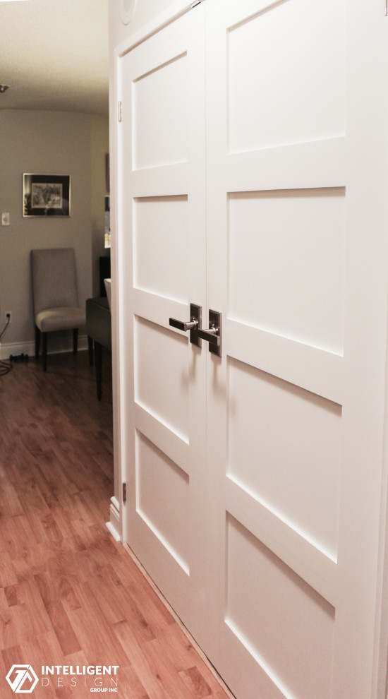 Inspiration for a small transitional gender-neutral laminate floor built-in closet remodel in Toronto with shaker cabinets