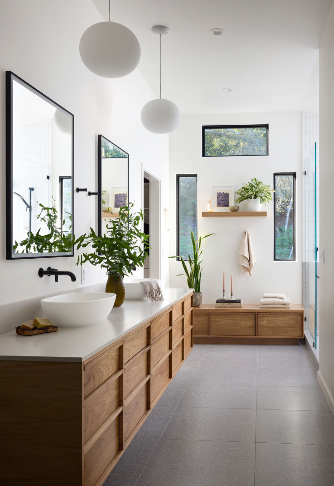 Inspiration for a contemporary master gray floor and double-sink bathroom remodel with flat-panel cabinets, medium tone wood cabinets, white walls, a vessel sink, white countertops and a floating vanity