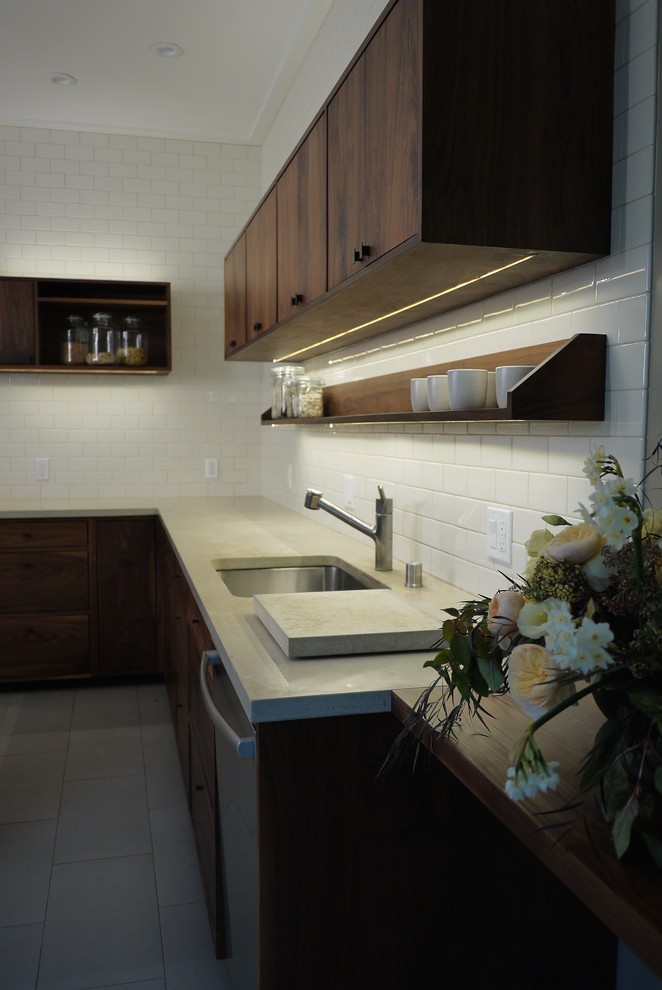 Mid-sized modern l-shaped separate kitchen in San Francisco with an undermount sink, flat-panel cabinets, dark wood cabinets, white splashback, subway tile splashback, stainless steel appliances, ceramic floors and with island.