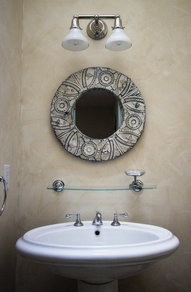 Photo of a small contemporary powder room in New York with a pedestal sink.