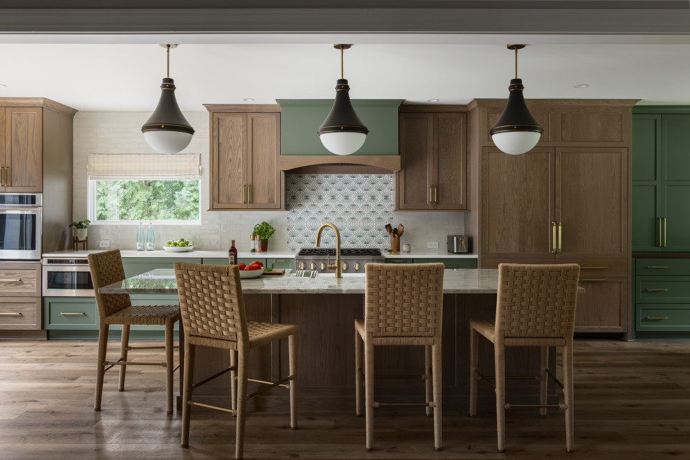 Kitchen - transitional galley dark wood floor and brown floor kitchen idea in Louisville with a farmhouse sink, recessed-panel cabinets, medium tone wood cabinets, gray backsplash, paneled appliances, an island and white countertops